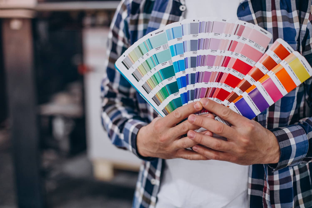 man-working-printing-house-with-paper-paints